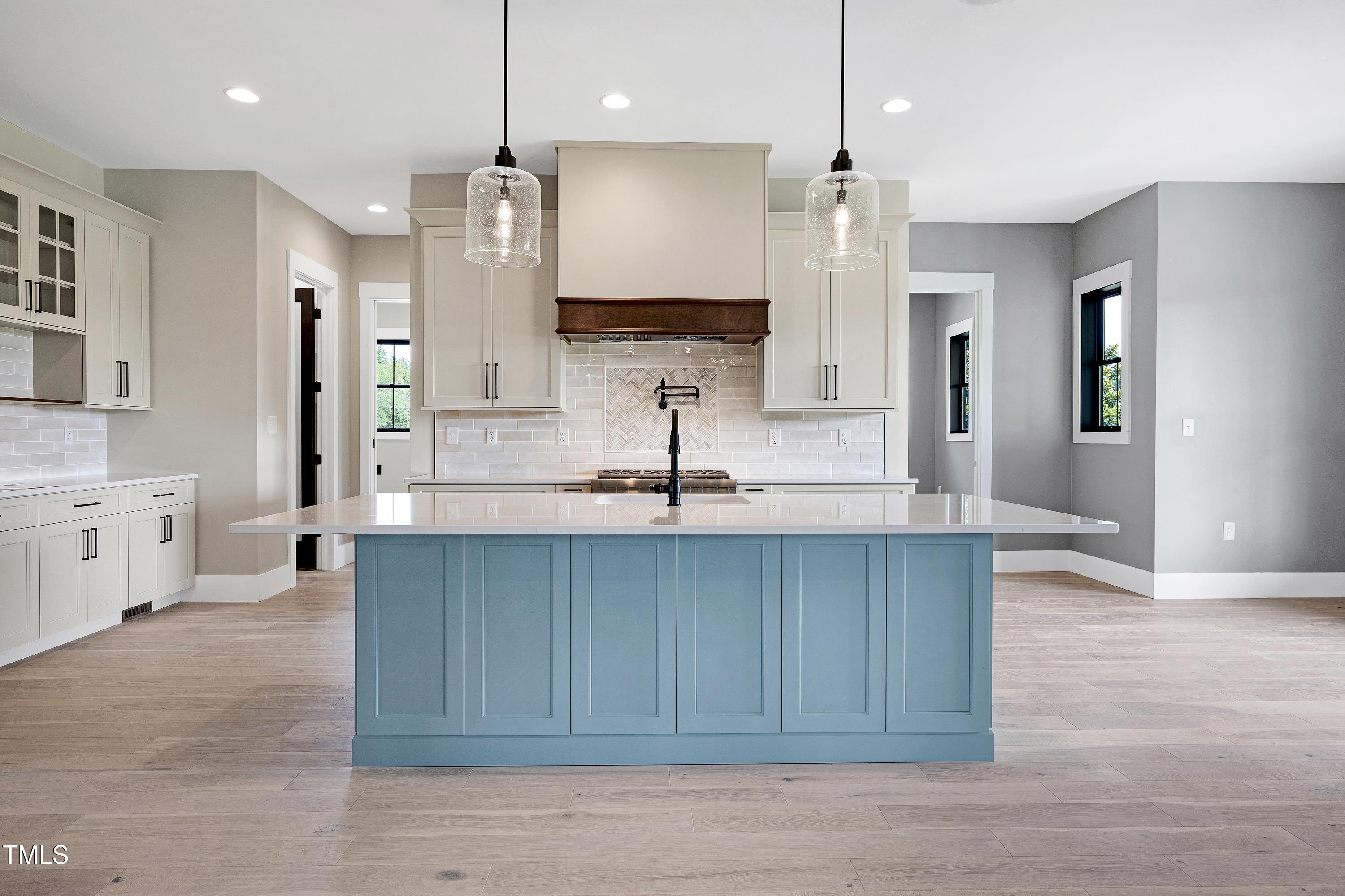 6509 Zebulon Road Wake Forest, NC 27587 - Photo 50 of 100 a large kitchen with stainless steel appliances a large counter top a sink a refrigerator and a window