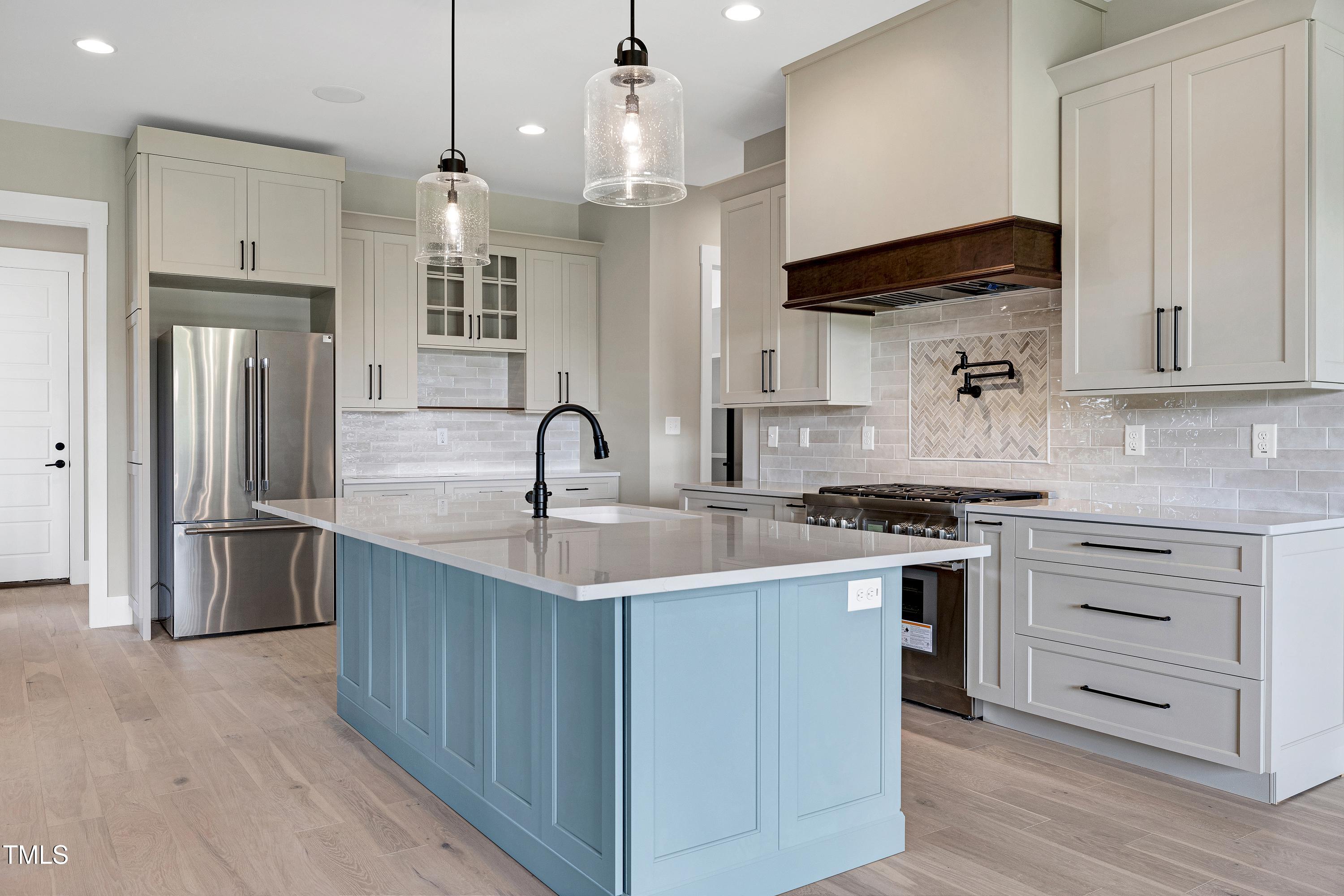 6509 Zebulon Road Wake Forest, NC 27587 - Photo 51 of 100 a kitchen with stainless steel appliances granite countertop a sink a stove and a refrigerator