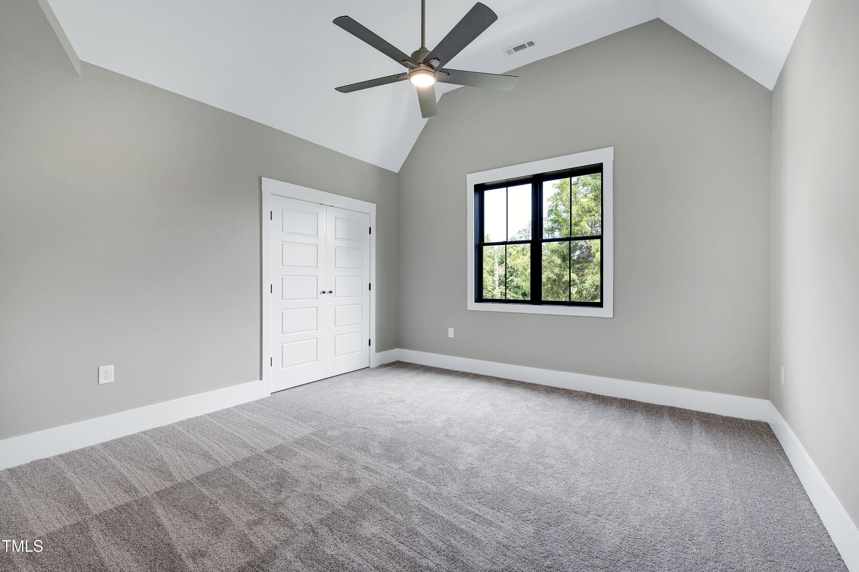 6509 Zebulon Road Wake Forest, NC 27587 - Photo 74 of 100 an empty room with a window and a ceiling fan
