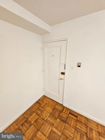 a view of a room with wooden floor