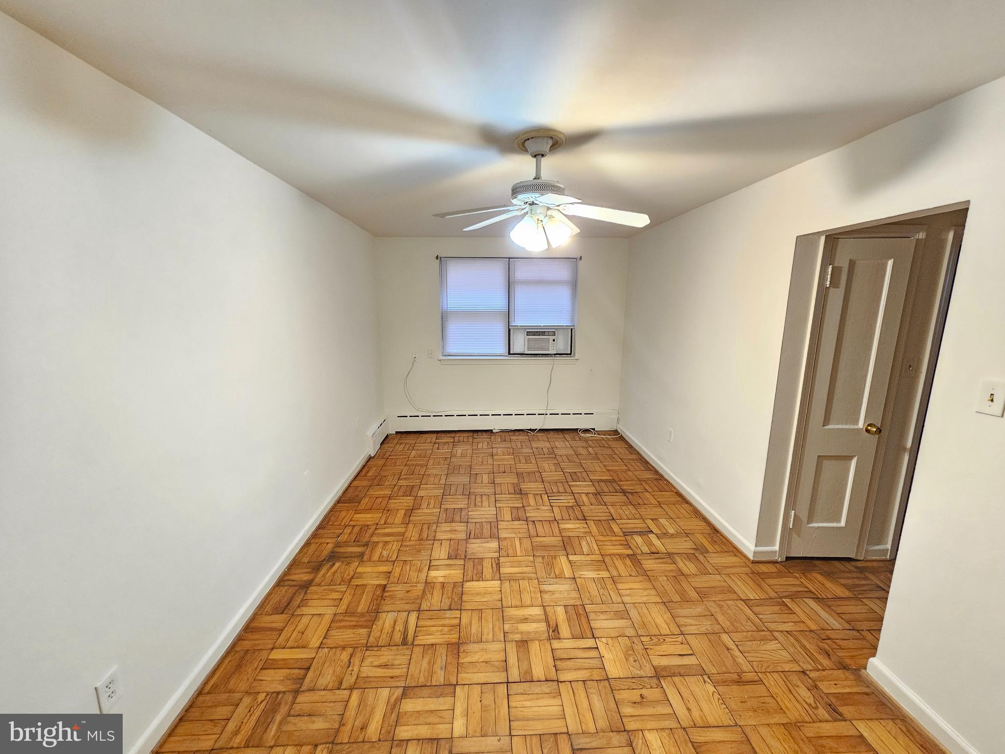 8711 Plymouth Street, Unit 1 Silver Spring, MD 20901 - Photo 3 of 14 en empty room with window and chandelier fan