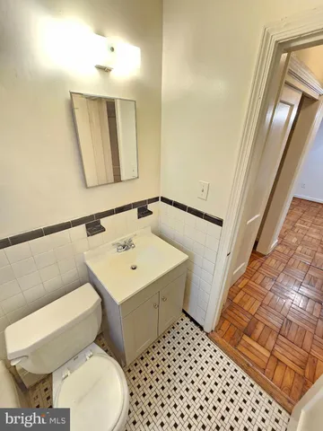 a bathroom with a toilet a sink and a mirror