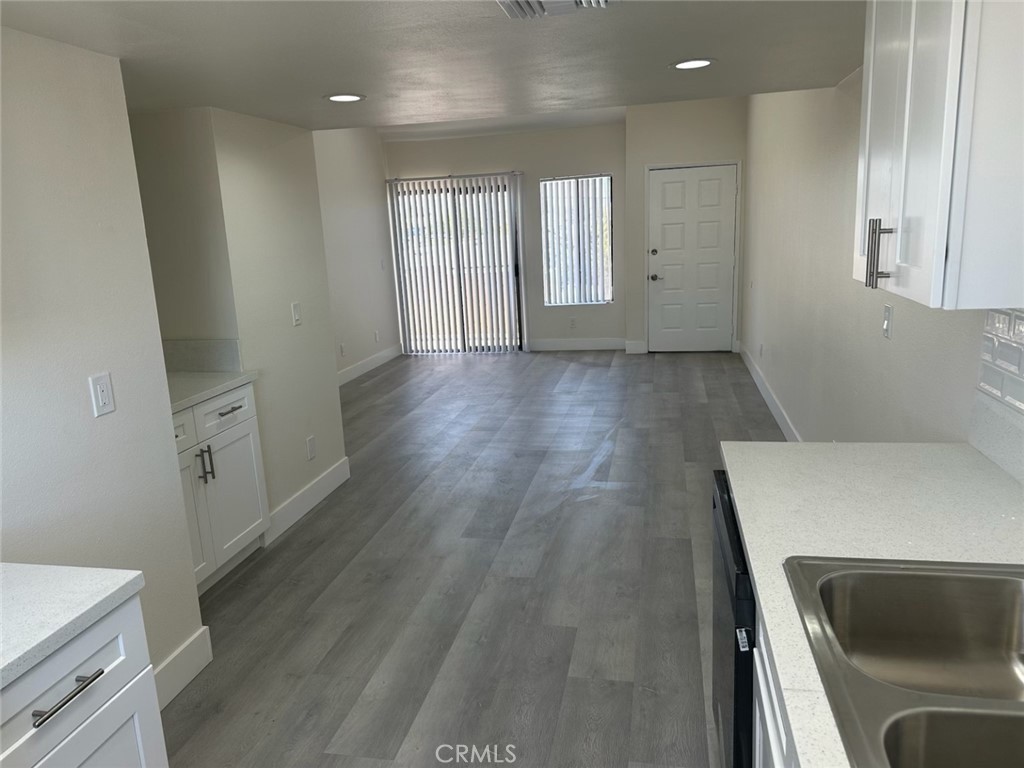 44155 10th Lancaster, CA 93534 - Photo 4 of 15 wooden floor in an empty room with a window