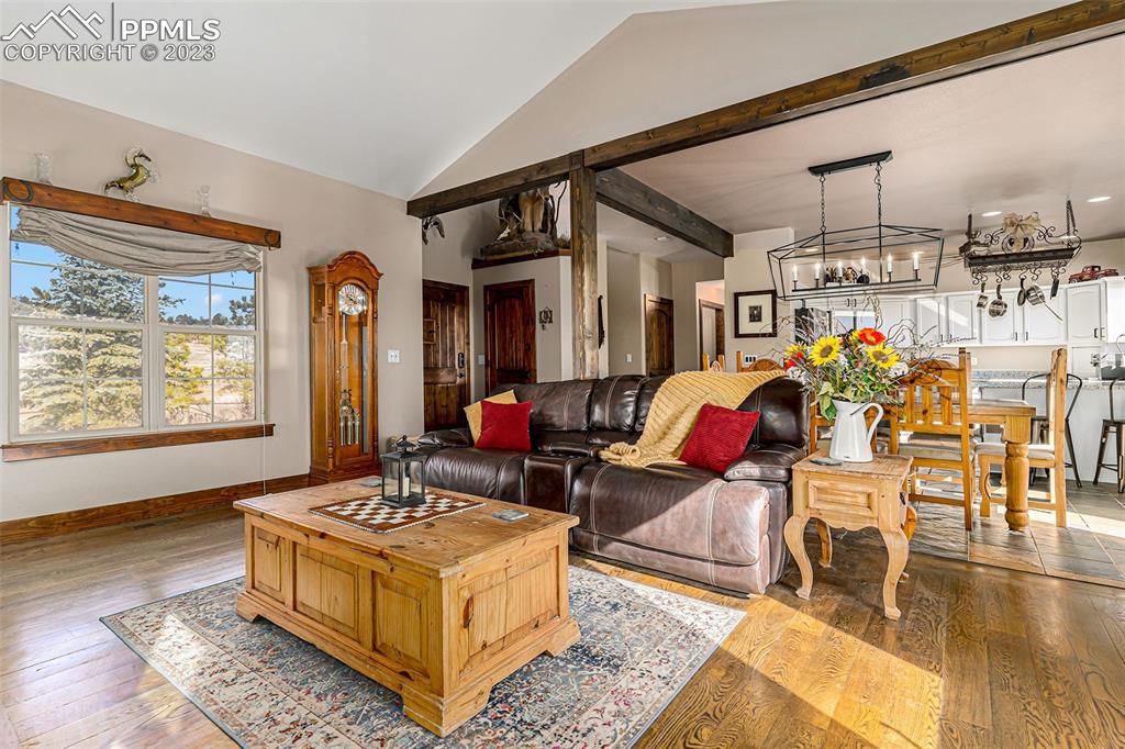 14965 Tanner Trail Elbert, CO 80106 - Photo 13 of 50 a living room with furniture and a chandelier