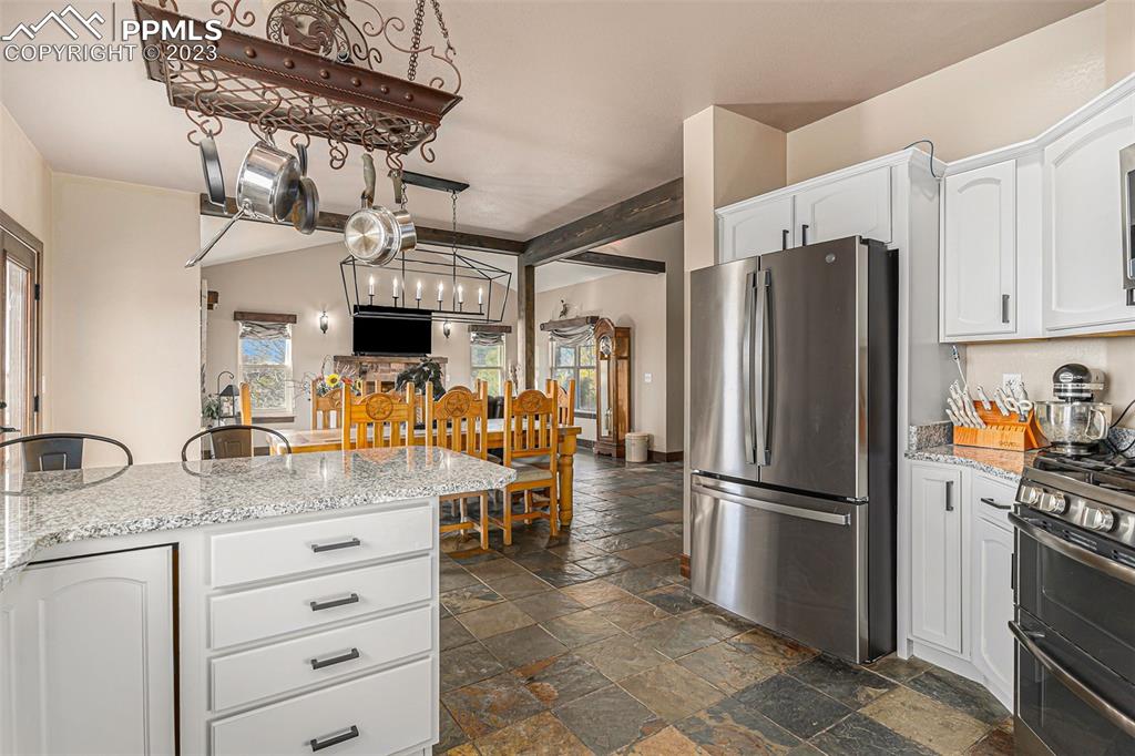 14965 Tanner Trail Elbert, CO 80106 - Photo 19 of 50 a kitchen with refrigerator and cabinets