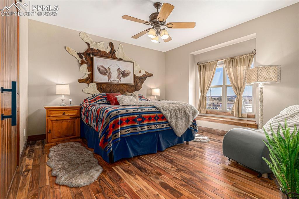 14965 Tanner Trail Elbert, CO 80106 - Photo 20 of 50 a bedroom with a bed and wooden floor