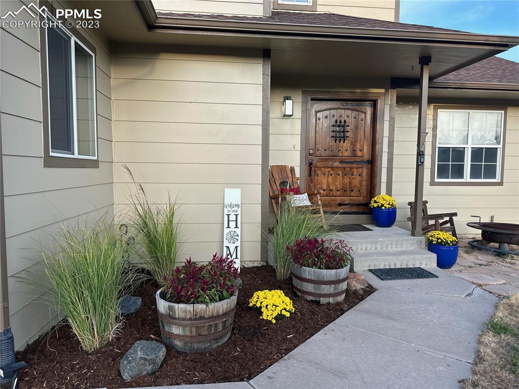 14965 Tanner Trail Elbert, CO 80106 - Photo 2 of 50 a view of a porch with chairs and potted plants