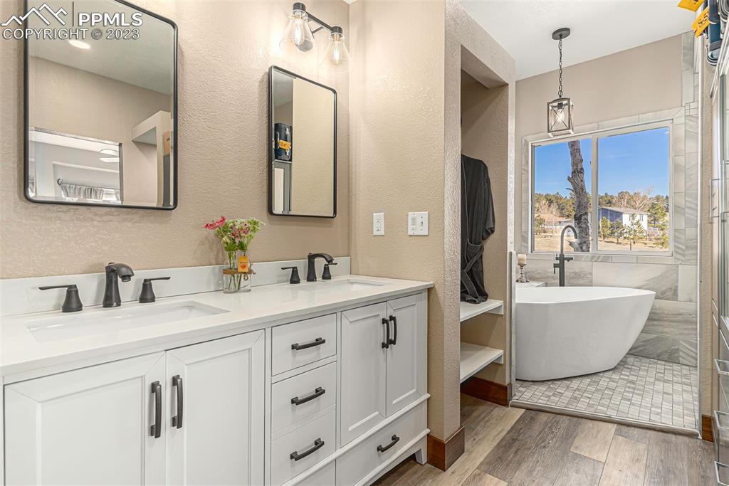14965 Tanner Trail Elbert, CO 80106 - Photo 23 of 50 a bathroom with a granite countertop sink mirror and bathtub