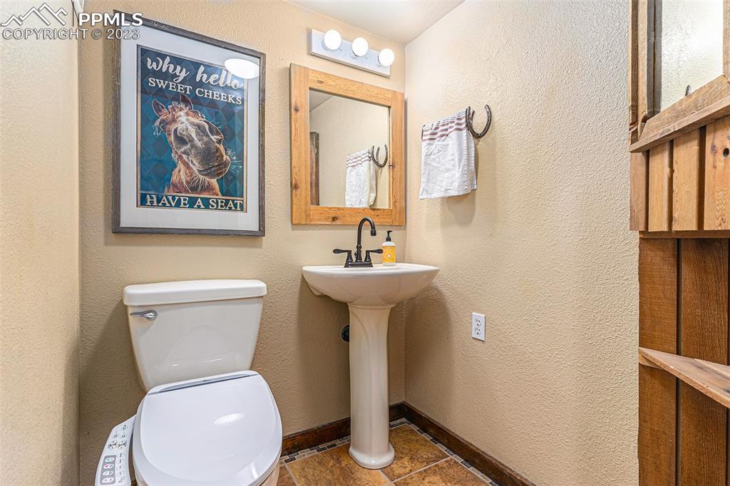 14965 Tanner Trail Elbert, CO 80106 - Photo 26 of 50 a white toilet sitting next to a bathroom sink