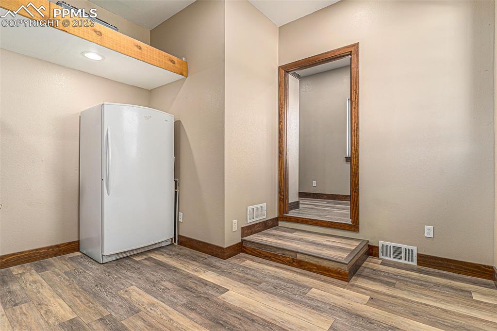 14965 Tanner Trail Elbert, CO 80106 - Photo 27 of 50 a view of a livingroom with wooden floor and white doors