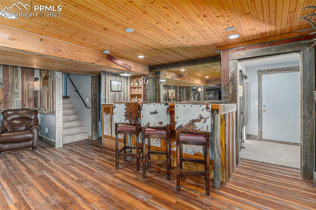 14965 Tanner Trail Elbert, CO 80106 - Photo 35 of 50 a view of a dining room with furniture and wooden floor