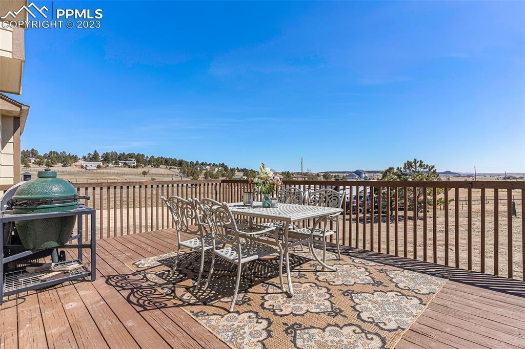 14965 Tanner Trail Elbert, CO 80106 - Photo 41 of 50 a view of a roof deck with chair and wooden floor