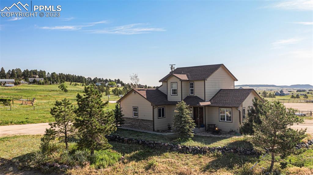 14965 Tanner Trail Elbert, CO 80106 - Photo 8 of 50 a front view of a house with a yard and lake view