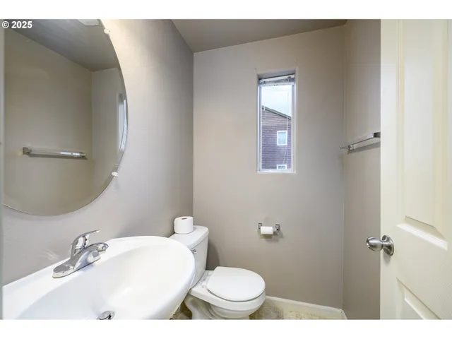 a bathroom with a sink toilet and mirror