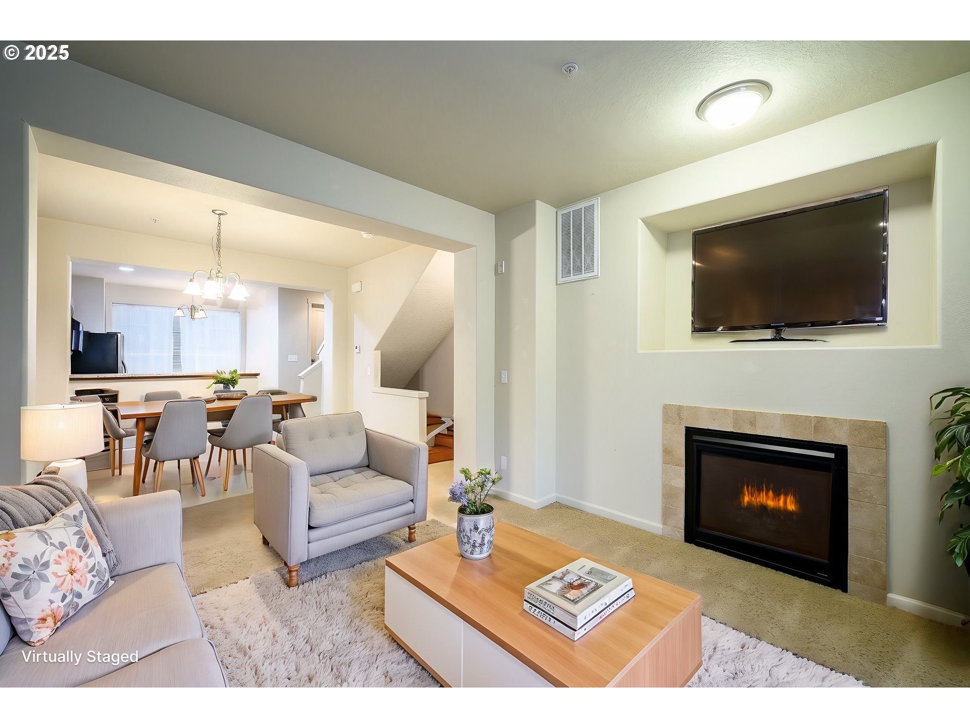 10795 Northeast Gateway Place Hillsboro, OR 97006 - Photo 3 of 27 a living room with furniture a flat screen tv and a fireplace