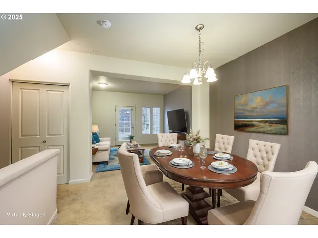 a view of a dining room with furniture and chandelier