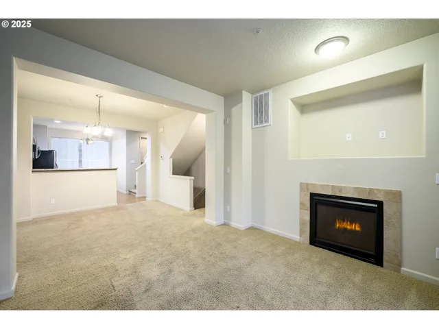 a view of an empty room and a fireplace