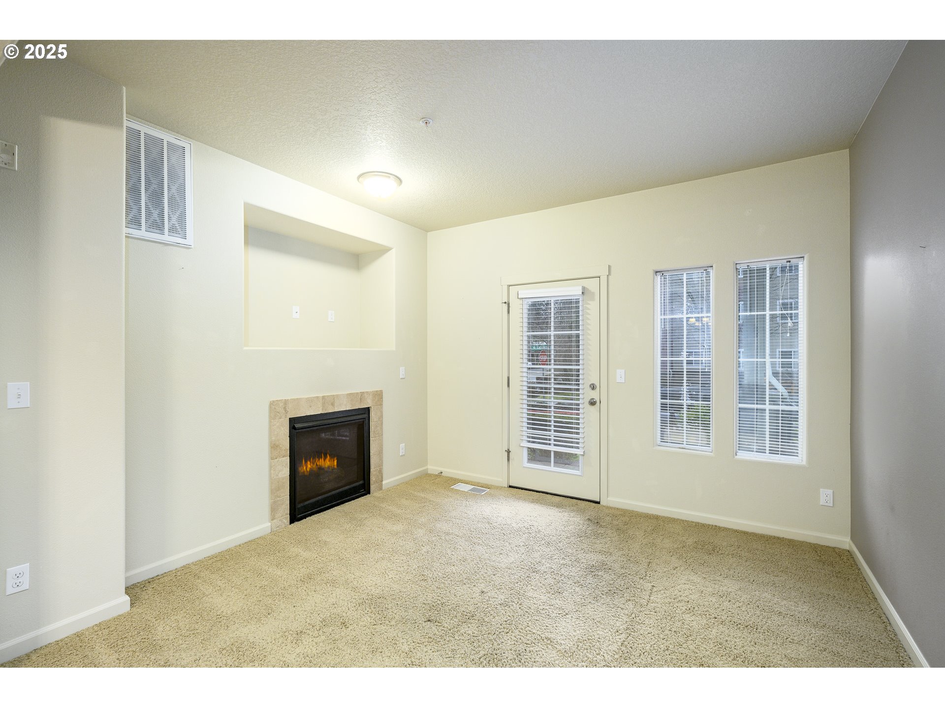 10795 Northeast Gateway Place Hillsboro, OR 97006 - Photo 8 of 27 a view of an empty room with a fireplace and window
