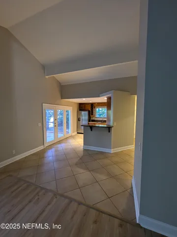 a view of empty room with a fireplace
