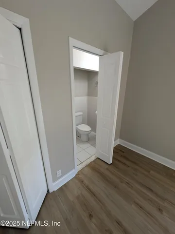 a view of walk in closet with wooden floor
