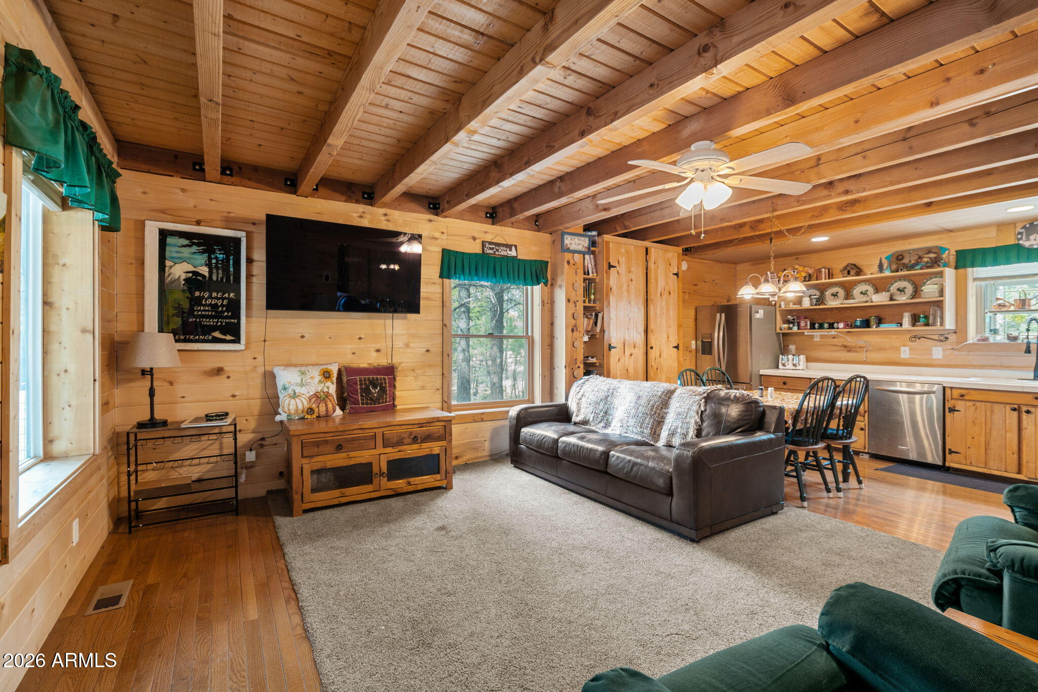 2095 Ranger Road Overgaard, AZ 85933 - Photo 5 of 25 a living room with furniture a flat screen tv and a fireplace
