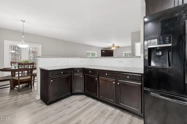 a kitchen with stainless steel appliances granite countertop a refrigerator a stove and a sink