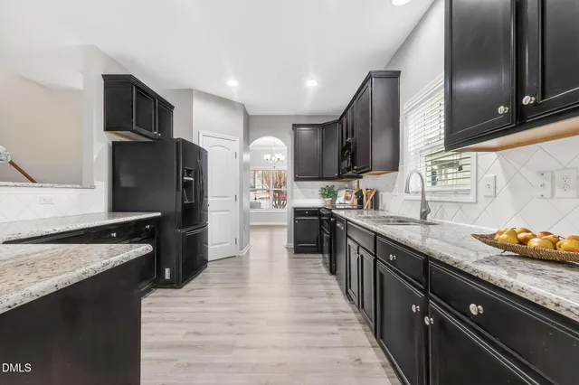 a kitchen with granite countertop stainless steel appliances and wooden cabinets