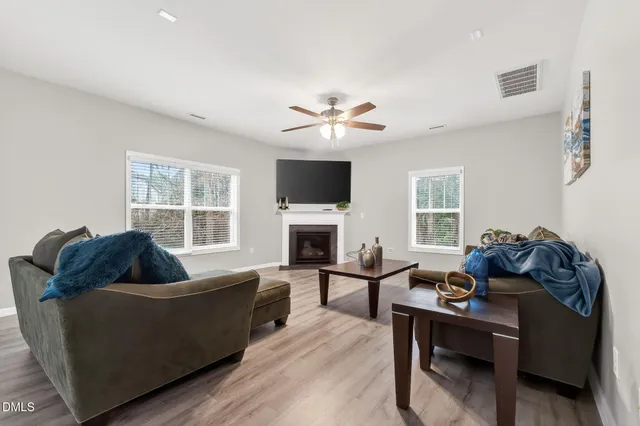 a living room with furniture and a fireplace
