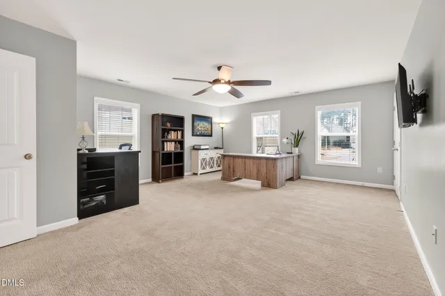 a view of a kitchen with furniture and a ceiling fan