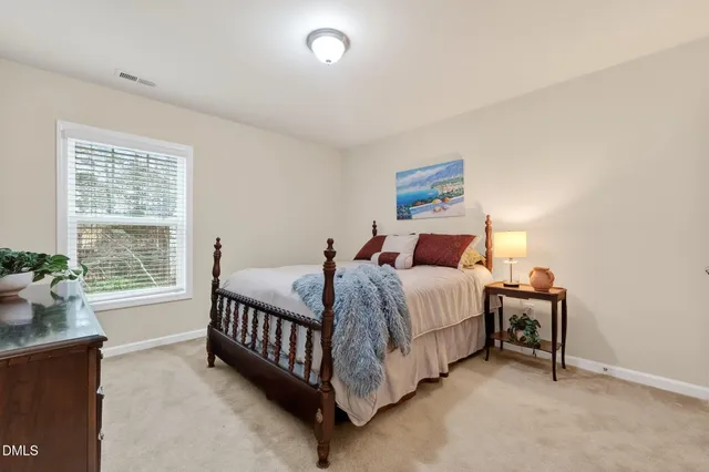 a bedroom with bed and wooden floor