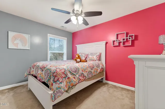 a large bed sitting in a bedroom next to a window