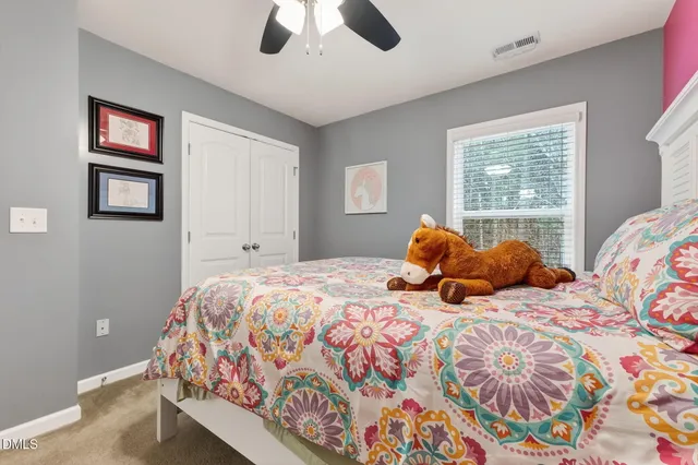 a bedroom with two beds and a chandelier