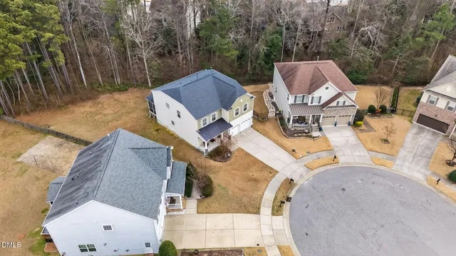 an aerial view of a house with swimming pool and porch
