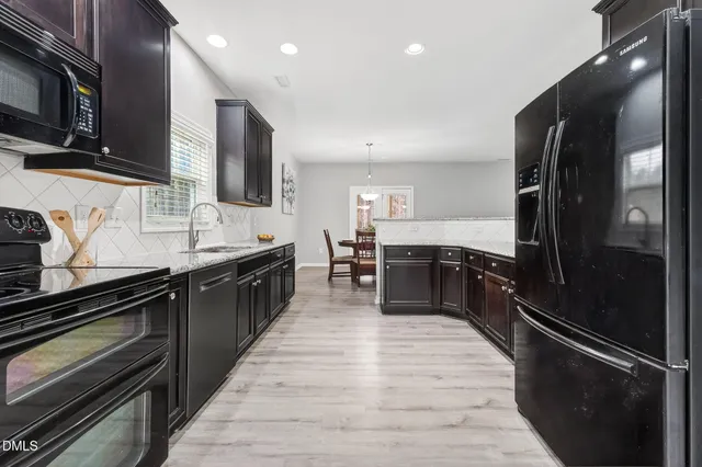 a large kitchen with stainless steel appliances