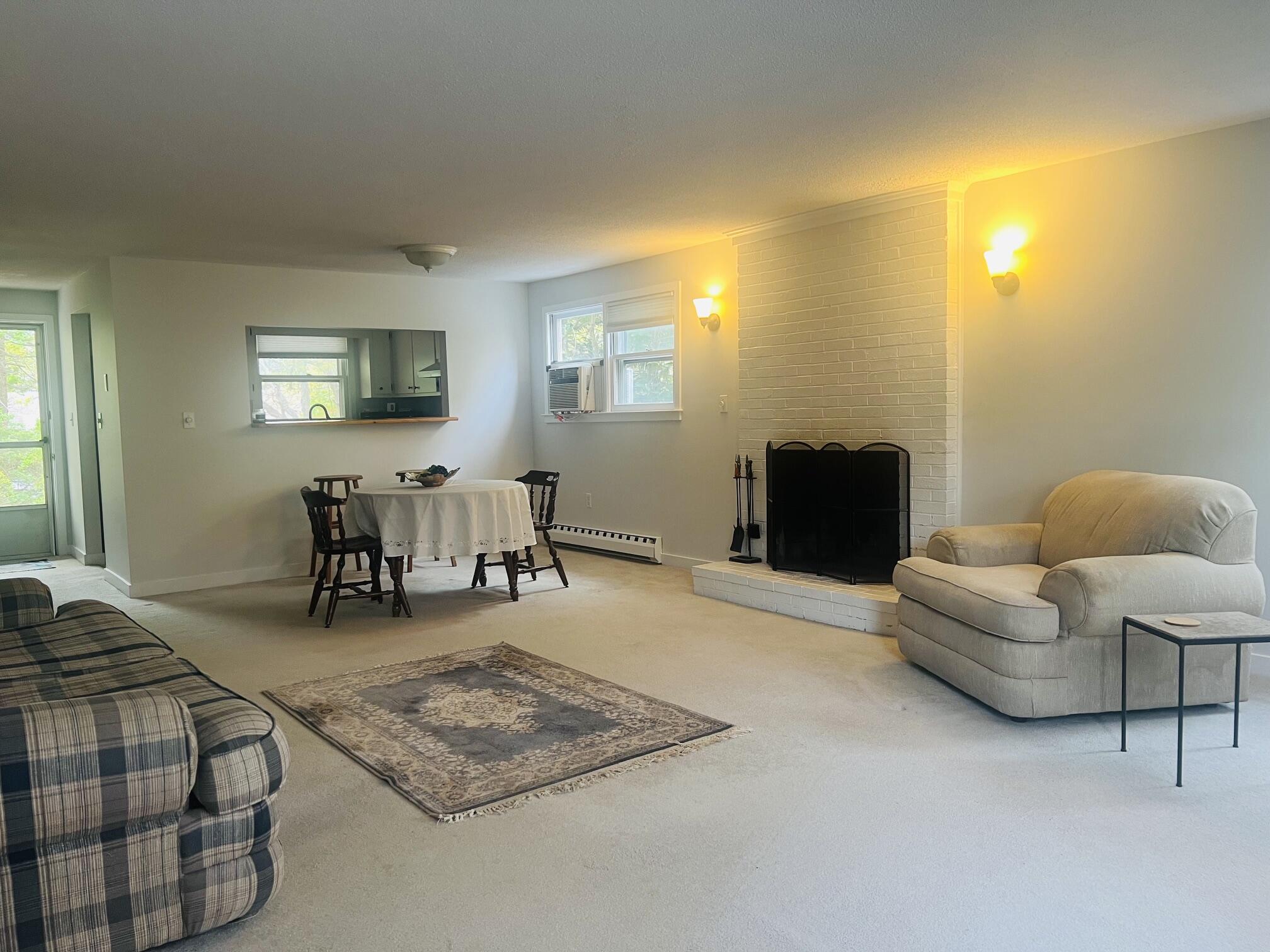 1431 Iyannough Road, Unit 1 Centerville, MA 02632 - Photo 17 of 28 a living room with furniture and a flat screen tv