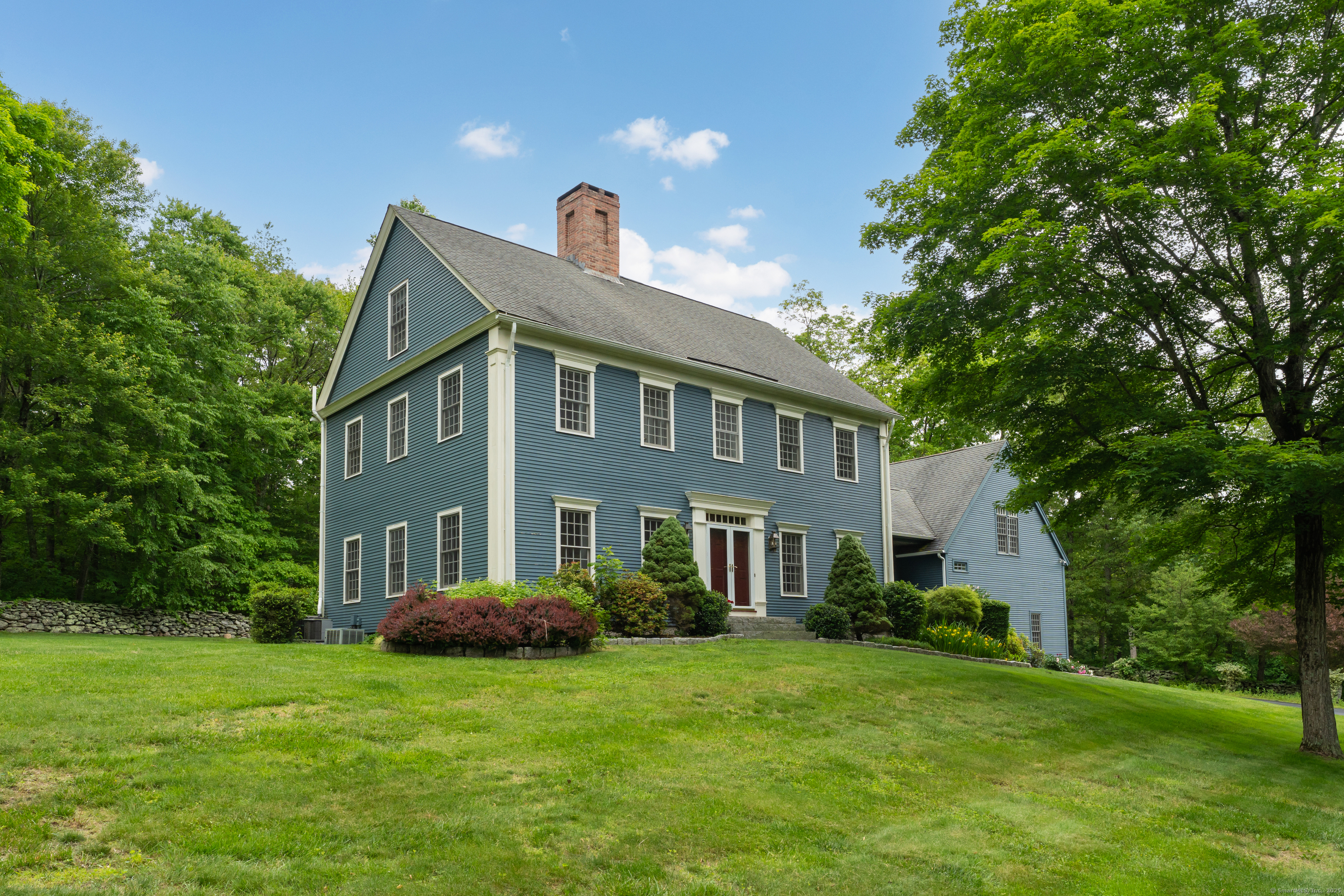 a front view of a house with a garden