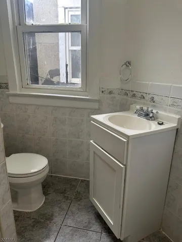 a bathroom with a sink toilet and a mirror