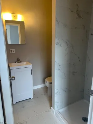 a bathroom with a sink a toilet and a shower