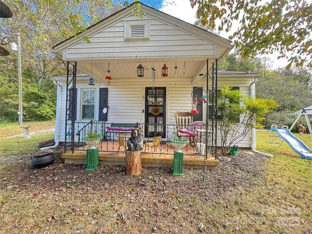 a backyard of a house with barbeque oven table and chairs