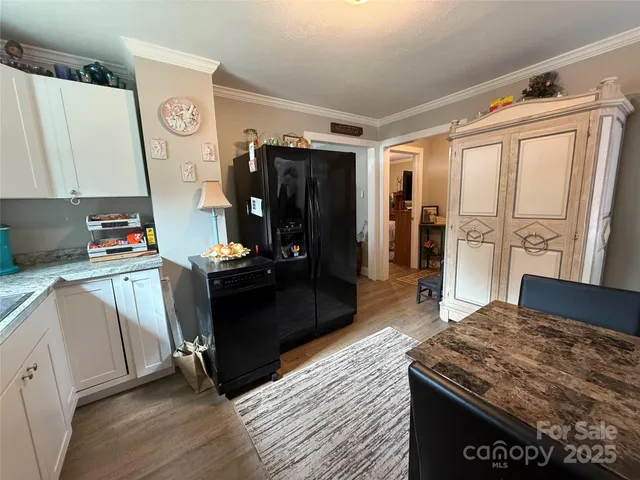 a kitchen with a refrigerator and a stove top oven