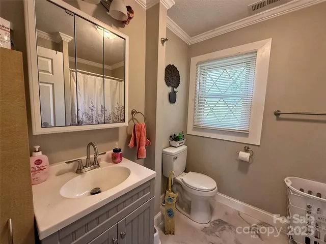 a bathroom with a sink toilet and mirror