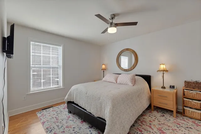a bedroom with a bed lamp closet and window