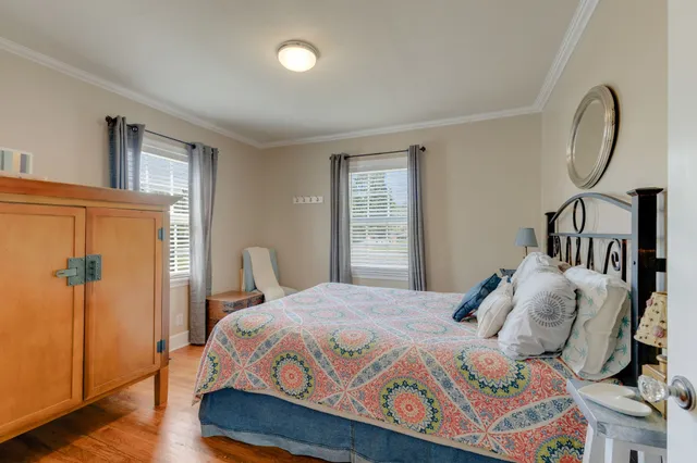 a bedroom with a bed a mirror and a window