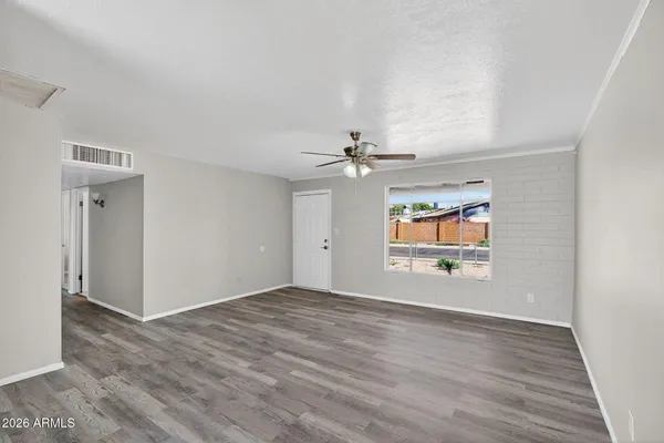 a kitchen with a refrigerator a sink cabinets and wooden floor