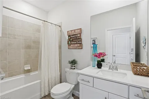 a bedroom with bed and wooden floor
