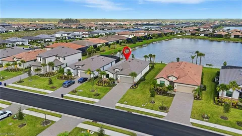 an aerial view of residential houses with outdoor space and river