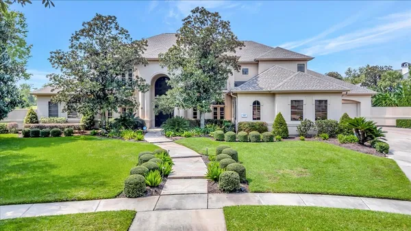 a front view of a house with a garden
