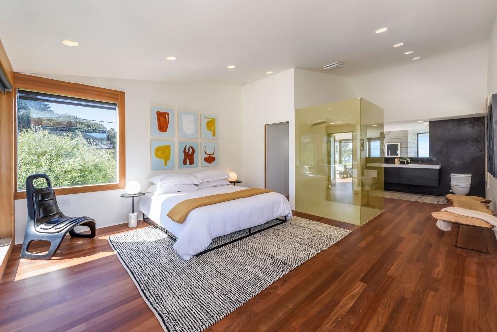 1241 Main Street Montara, CA 94037 - Photo 15 of 34 a bedroom with a bed and wooden floor