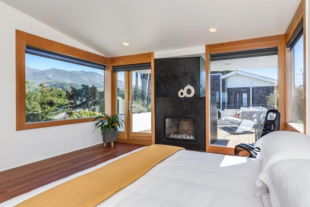 1241 Main Street Montara, CA 94037 - Photo 16 of 34 a bedroom with a bed and a large window with outer view
