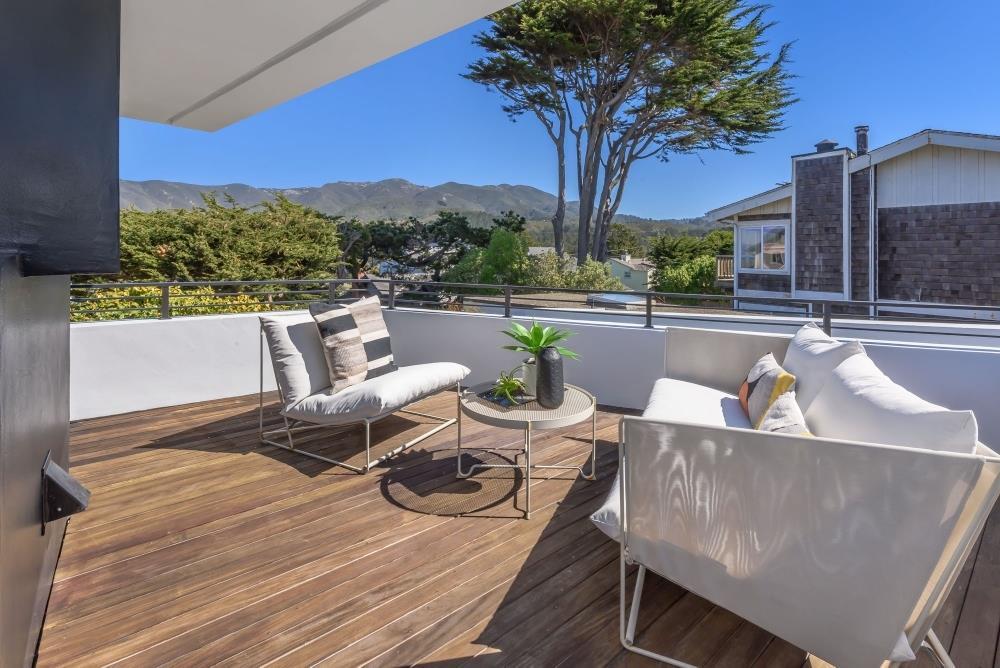 1241 Main Street Montara, CA 94037 - Photo 17 of 34 a view of a roof deck with couches and wooden floor